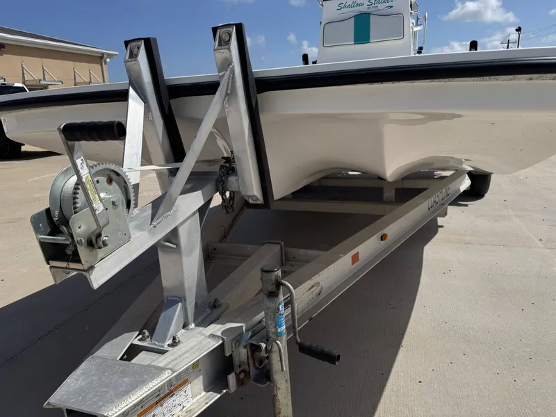 Slide: The Image of A 2024 Shallow Stalker 20 PRO boat on a trailer, ready for transport. - 5