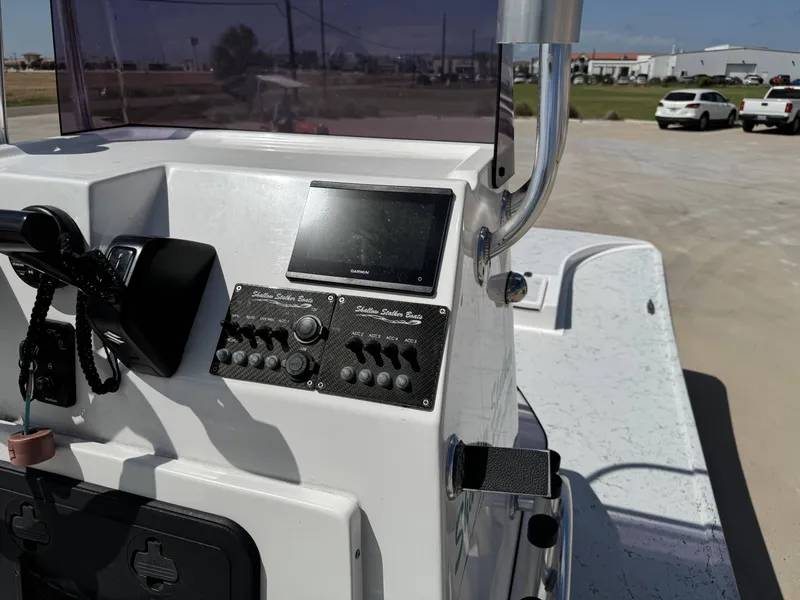 Slide: The Image of The image shows the helm of a 2024 Shallow Stalker 20 PRO boat. - 14