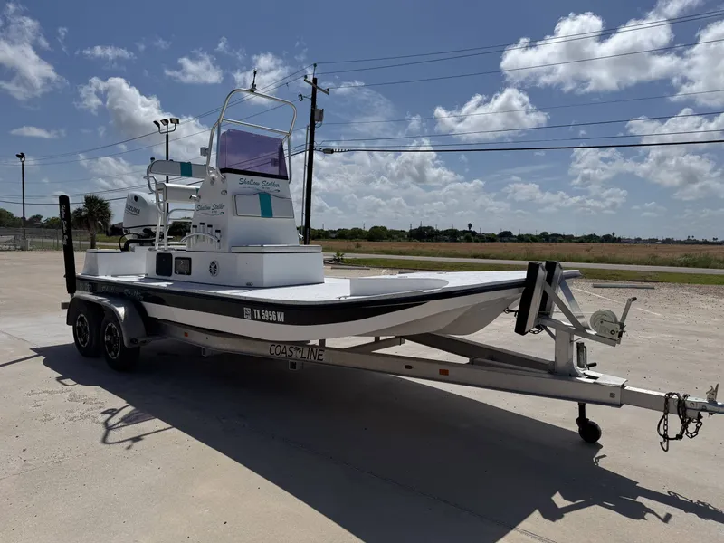 Slide: The Image of A 2024 Shallow Stalker 20 PRO boat on a trailer, ready for transport. - 6