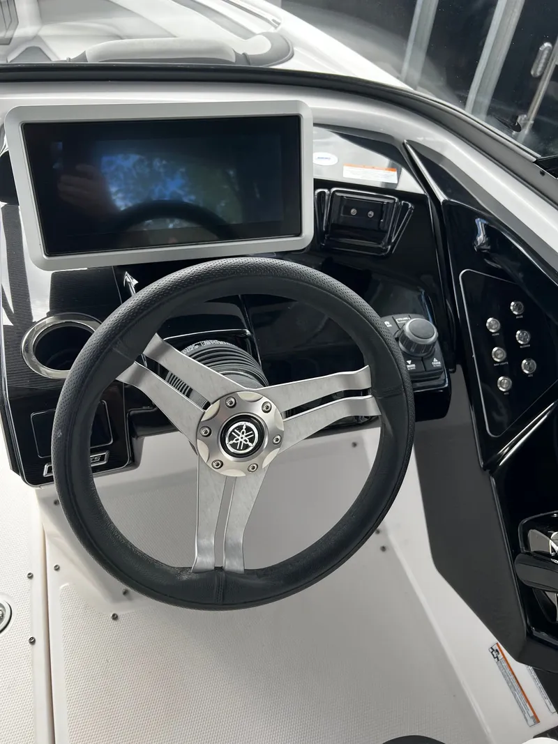 Slide: The Image of The image shows the helm of a 2022 Yamaha 252SE boat with a modern display. - 2