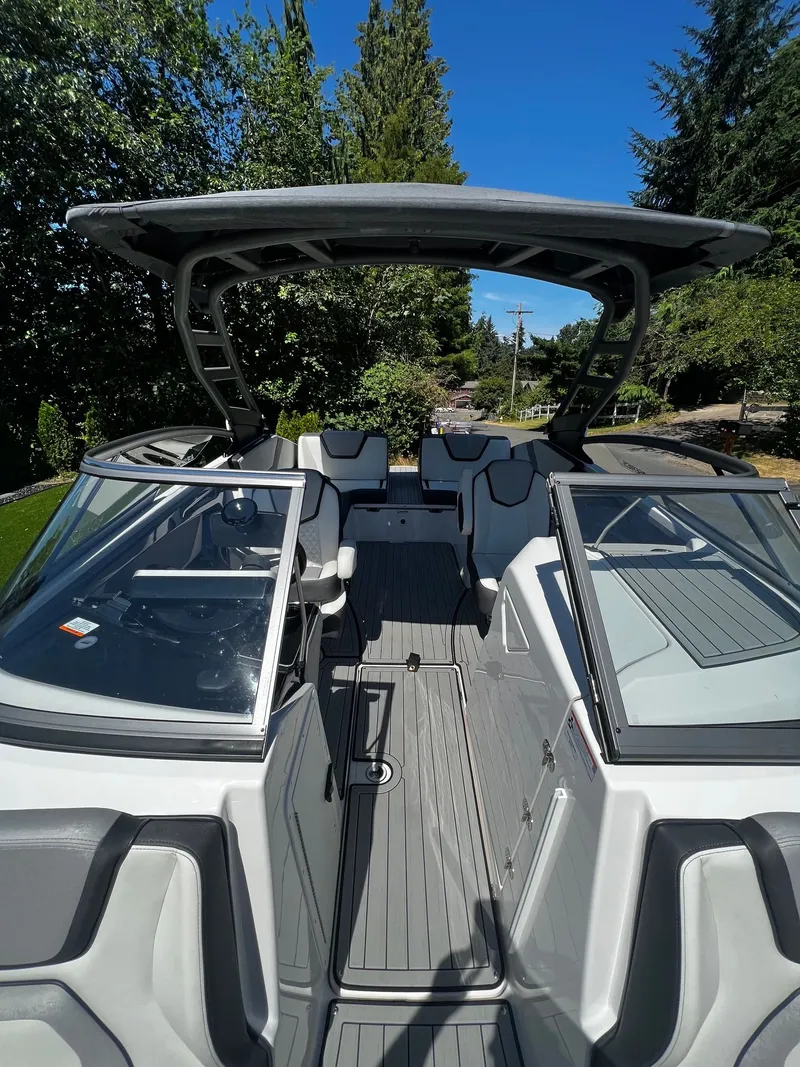 Slide: The Image of The image shows a modern 2022 Yamaha 252SE boat with sleek design and spacious interior. - 7