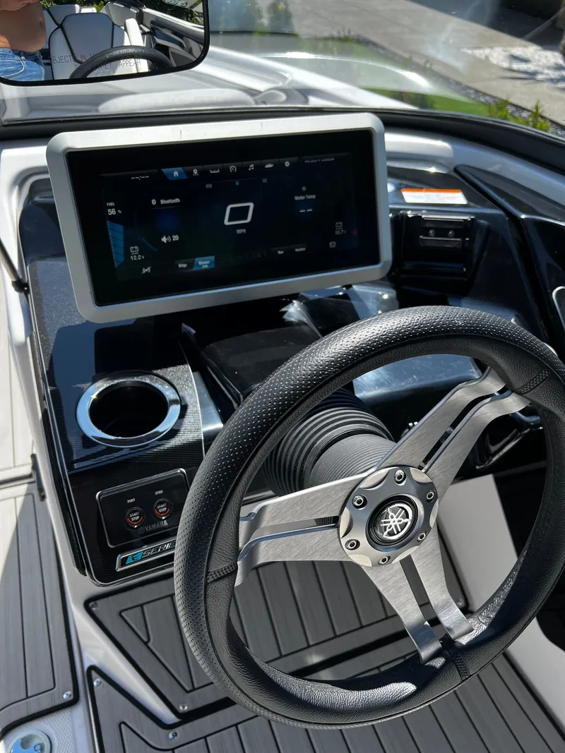 Slide: The Image of The image shows the helm of a Yamaha 252SE boat with a modern display and steering wheel. - 5