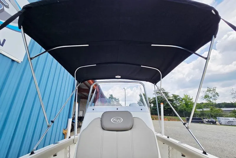Slide: The Image of 2023 Key West 188 Bay Reef boat with canopy, outdoor setting. - 29