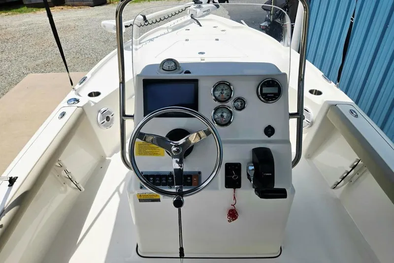 Slide: The Image of 2023 Key West 188 Bay Reef boat dashboard with steering wheel and gauges. - 32