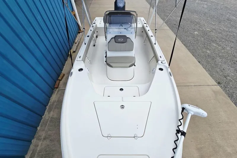 Slide: The Image of 2023 Key West 188 Bay Reef boat, white interior, docked beside a blue wall. - 19