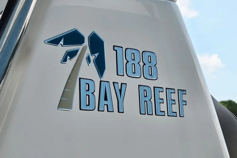 Slide: The Image of Key West 188 Bay Reef 2023 logo on boat exterior with palm tree design. - 18