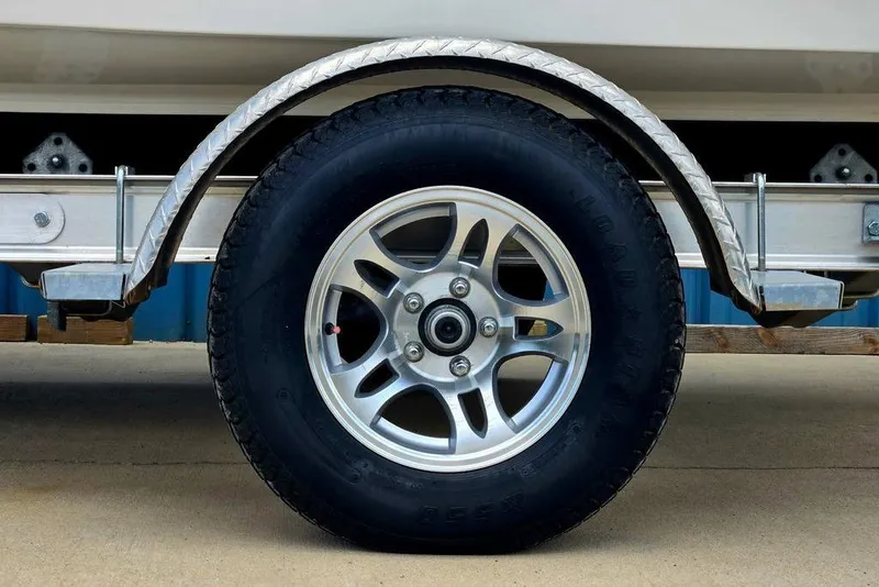 Slide: The Image of Trailer wheel of 2023 Key West 188 Bay Reef boat, featuring alloy rim and tire. - 13
