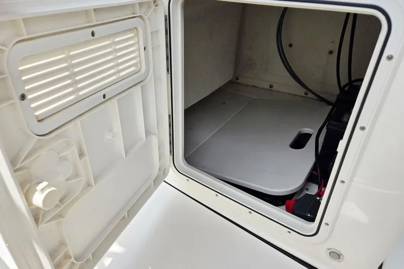 Slide: The Image of Open storage compartment on 2023 Key West 188 Bay Reef boat, showing interior space and wiring. - 31
