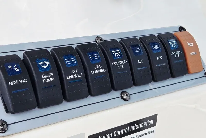 Slide: The Image of Control panel of 2023 Key West 188 Bay Reef boat with labeled switches. - 39
