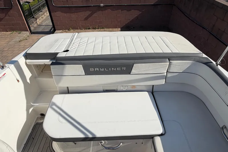 Slide: The Image of 2018 Bayliner VR5 Bowrider I/O interior with white seating and Bayliner branding. - 21