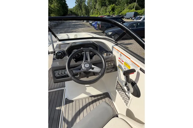 Slide: The Image of 2018 Bayliner VR5 Bowrider I/O cockpit with steering wheel and control panel. - 30