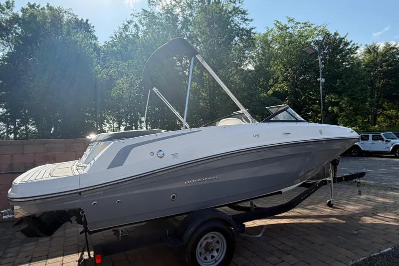 The Image of 2018 Bayliner VR5 Bowrider I/O on trailer, parked outdoors with trees in background. - 0