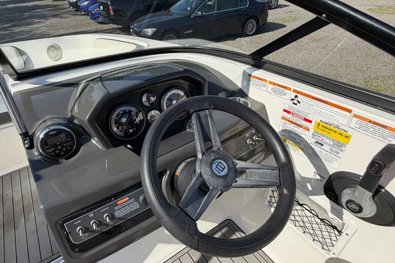 Slide: The Image of 2018 Bayliner VR5 Bowrider I/O dashboard with steering wheel and control panel. - 15