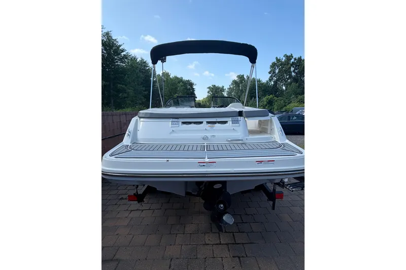 Slide: The Image of 2018 Bayliner VR5 Bowrider I/O boat, rear view, parked on paved surface. - 7