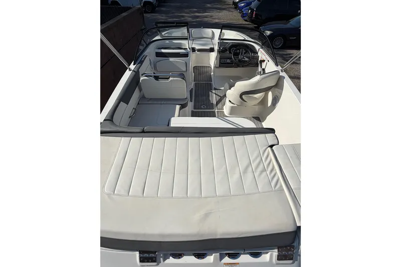 Slide: The Image of 2018 Bayliner VR5 Bowrider I/O interior with white seating and steering console. - 24