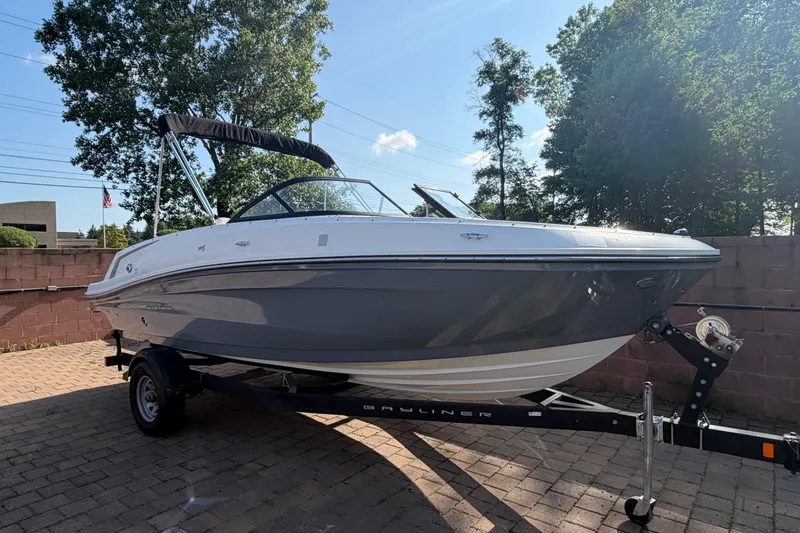 Slide: The Image of 2018 Bayliner VR5 Bowrider I/O boat on trailer, parked outdoors on a sunny day. - 1