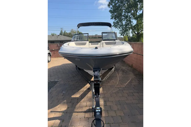 Slide: The Image of 2018 Bayliner VR5 Bowrider I/O on trailer, parked on brick driveway under clear sky. - 3