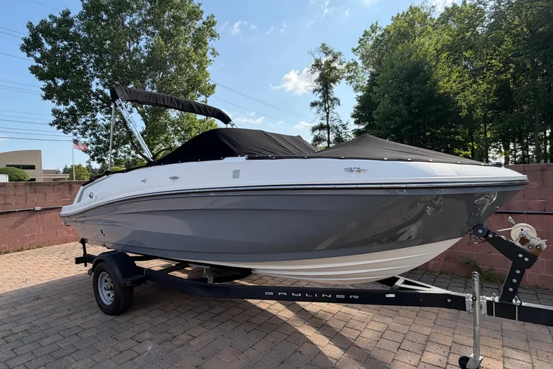 Slide: The Image of 2018 Bayliner VR5 Bowrider I/O on trailer, covered, parked on brick pavement. - 5