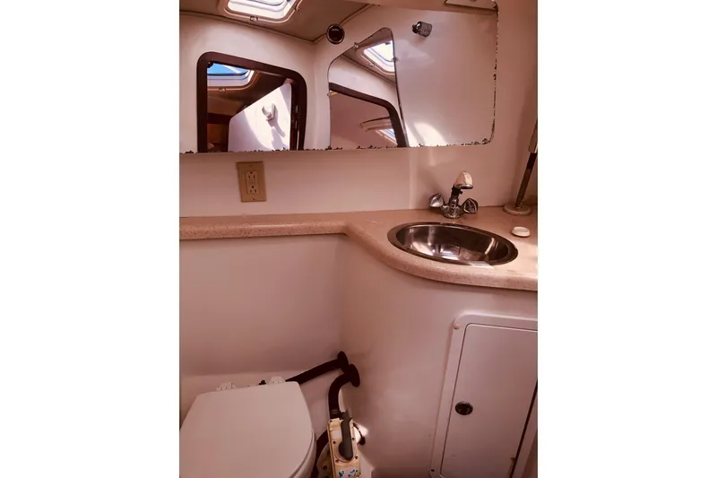 Slide: The Image of 1999 Catalina 400 yacht bathroom with sink, mirror, and toilet. - 11