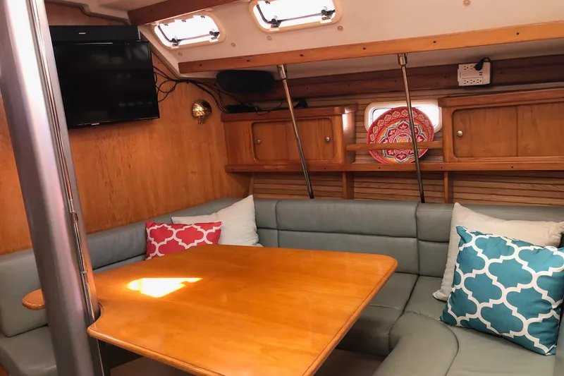 Slide: The Image of Cozy interior of 1999 Catalina 400 sailboat with cushioned seating and decorative pillows. - 4