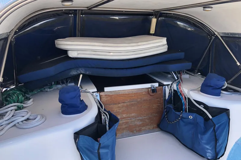 Slide: The Image of Interior view of a 1999 Catalina 400 sailboat cockpit with cushions and storage. - 18