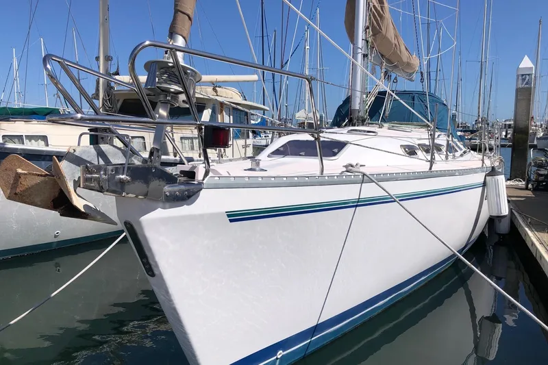 The Image of 1999 Catalina 400 sailboat docked in marina, featuring sleek white hull and blue accents. - 0