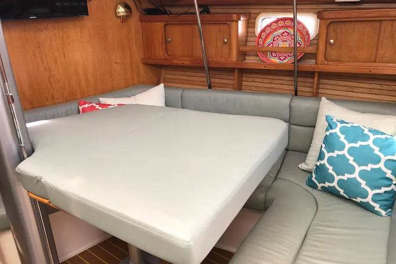 Slide: The Image of Interior of 1999 Catalina 400 yacht with cozy seating and decorative pillows. - 12