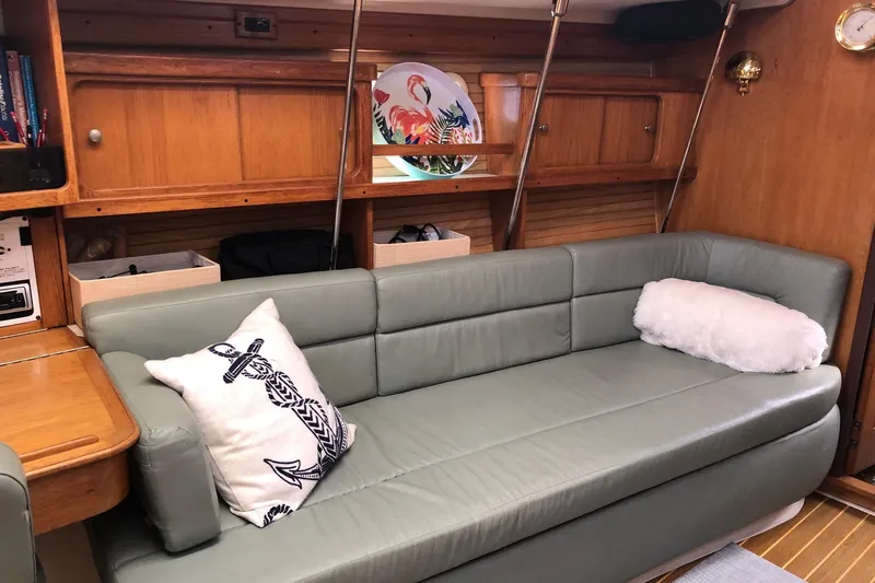 Slide: The Image of Interior of a 1999 Catalina 400 yacht with a cozy sofa and nautical decor. - 5