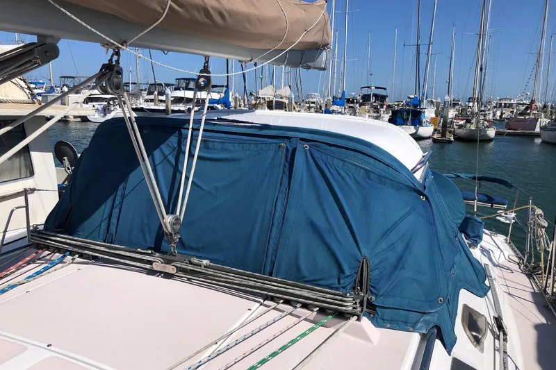 Slide: The Image of Sailboat Catalina 400 (1999) docked in marina with blue canvas cover. - 17