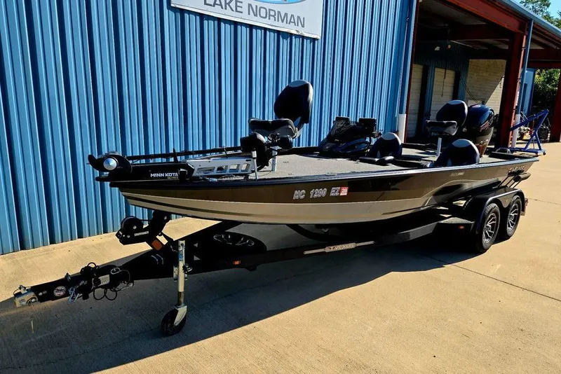 Slide: The Image of 2022 Vexus AVX1980 boat on trailer, parked outside blue building at Lake Norman. - 6