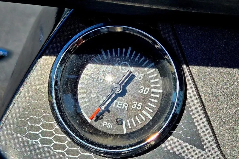 Slide: The Image of Close-up of a pressure gauge on a 2022 Vexus AVX1980 boat dashboard. - 35
