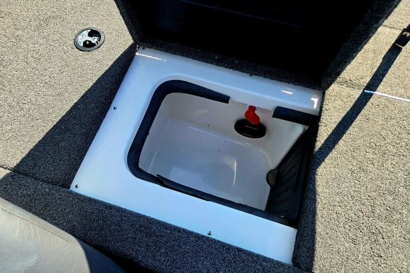 Slide: The Image of Open storage compartment in 2022 Vexus AVX1980 boat, featuring carpeted interior and latch. - 44