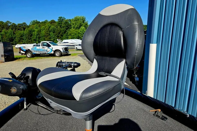 Slide: The Image of 2022 Vexus AVX1980 boat seat with black and gray upholstery, outdoors near a blue building. - 15