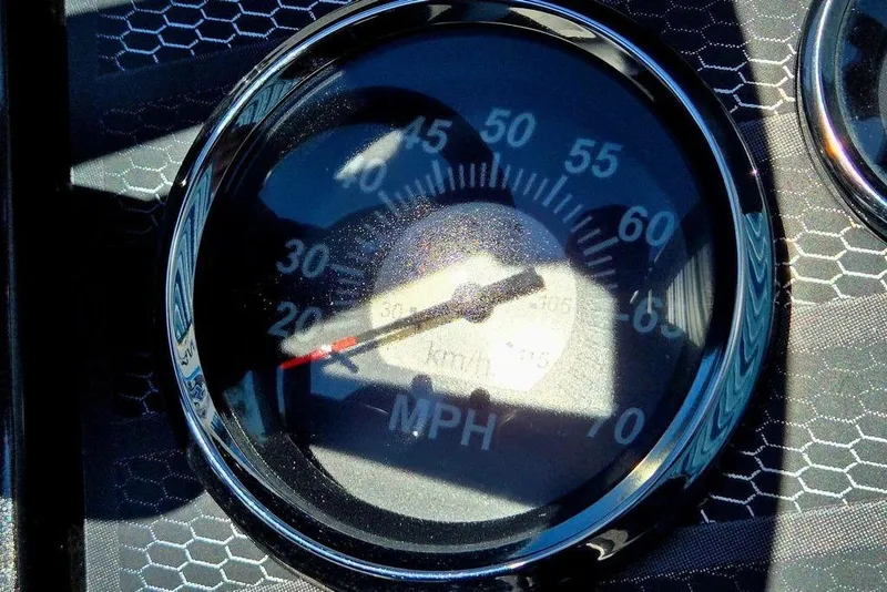 Slide: The Image of Speedometer of 2022 Vexus AVX1980 showing speed in MPH, with hexagonal pattern background. - 36