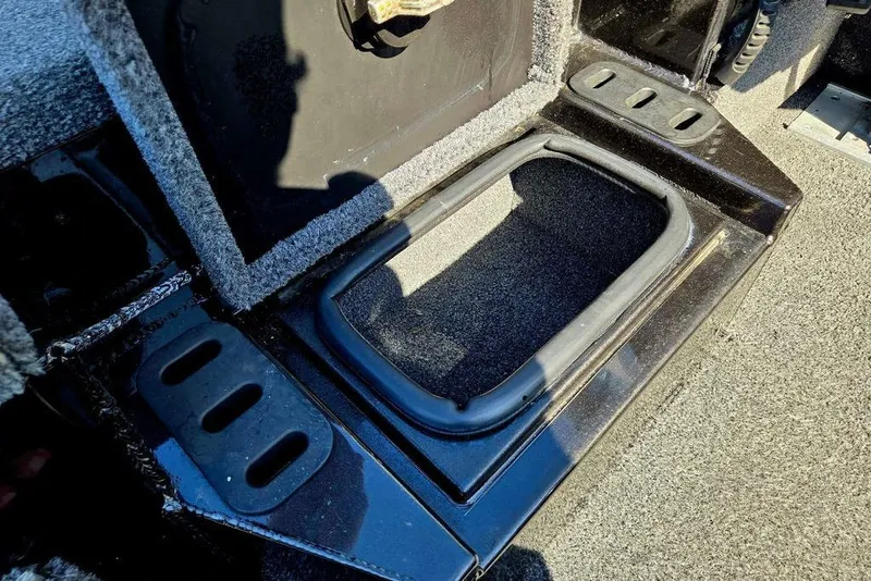 Slide: The Image of 2022 Vexus AVX1980 boat storage compartment with black trim and carpeted interior. - 29