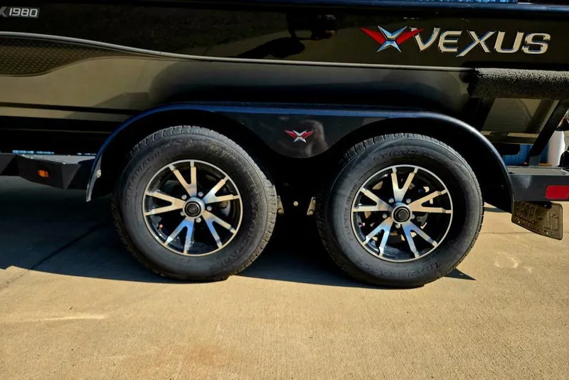 Slide: The Image of 2022 Vexus AVX1980 boat trailer with dual wheels and sleek black design. - 13