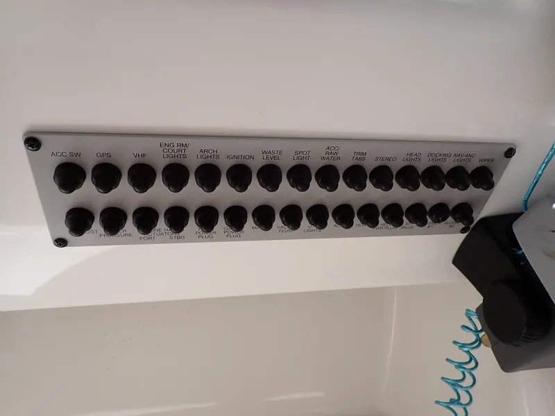 Slide: The Image of Control panel of a 2011 Chaparral 287 SSX boat with labeled switches. - 37