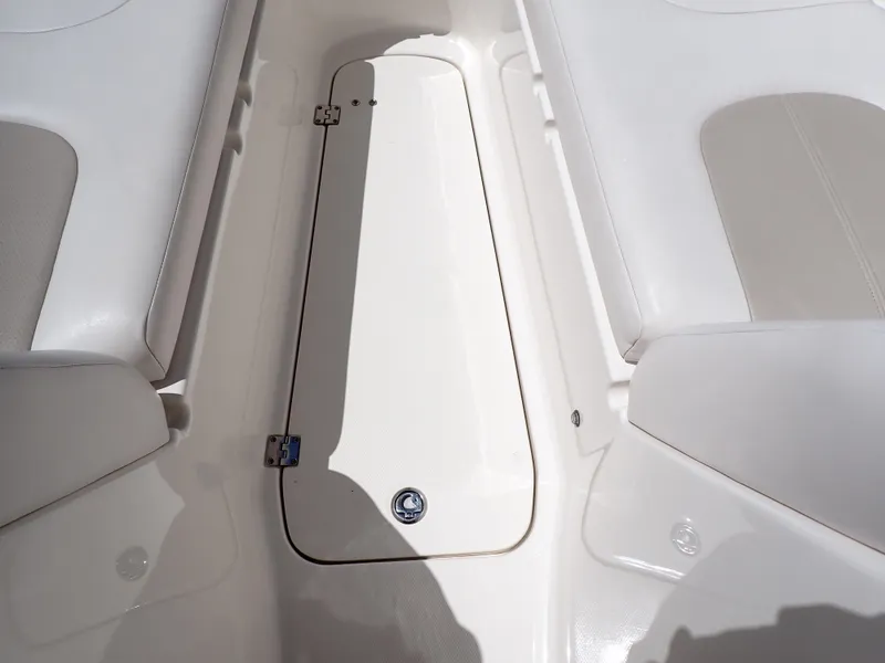 Slide: The Image of Interior view of 2011 Chaparral 287 SSX boat, featuring white seating and storage compartment. - 35
