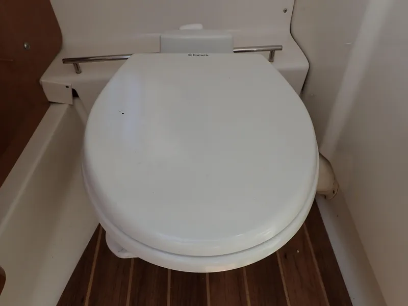 Slide: The Image of Boat toilet in 2011 Chaparral 287 SSX, featuring wooden flooring. - 48
