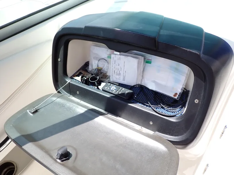 Slide: The Image of Storage compartment in a 2011 Chaparral 287 SSX boat, containing documents and accessories. - 43