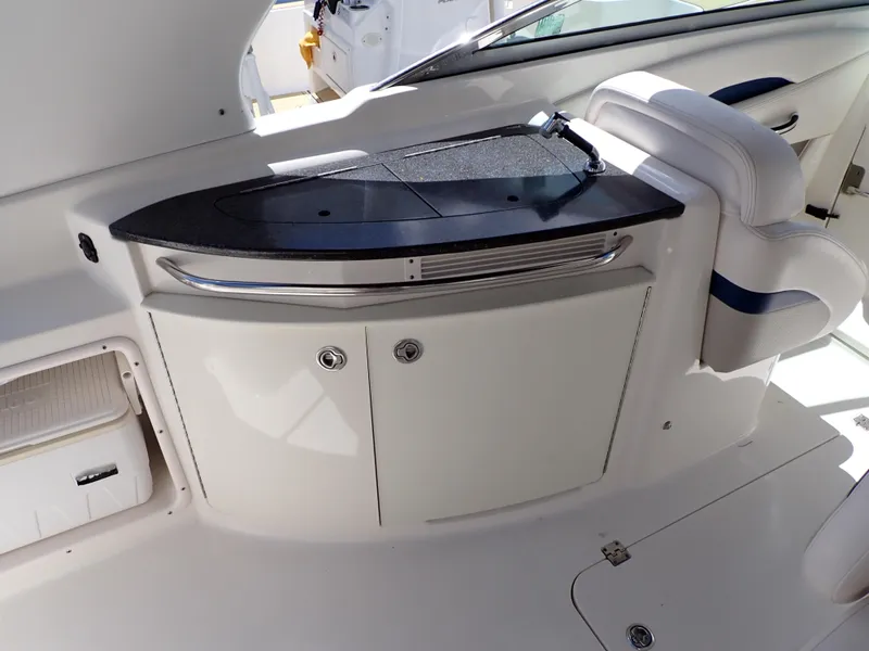 Slide: The Image of 2011 Chaparral 287 SSX boat interior with sleek black countertop and white cabinetry. - 9