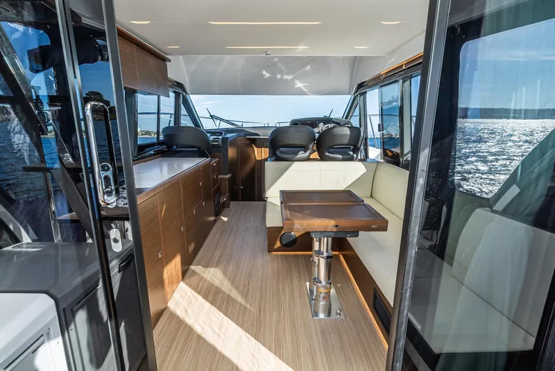 Slide: The Image of 2024 Bavaria R40 yacht interior with modern seating and ocean view. - 44