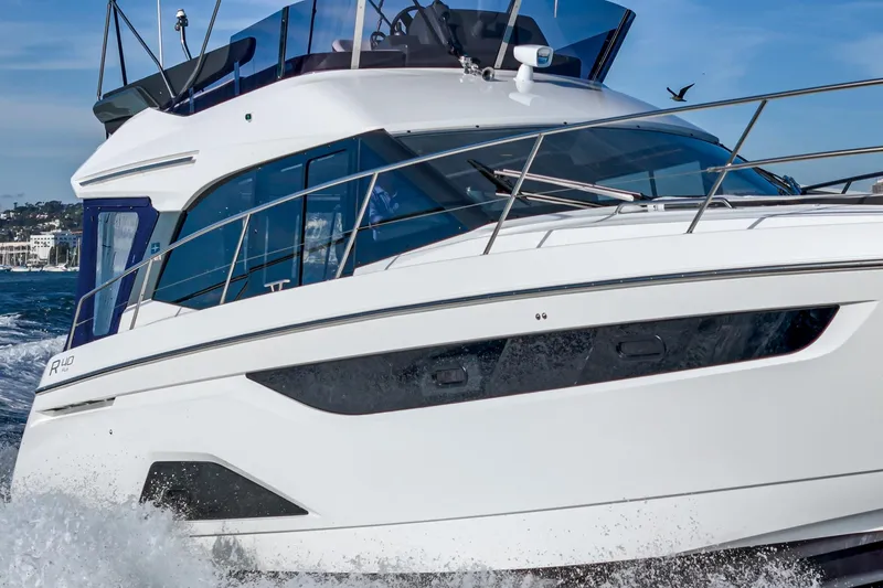 Slide: The Image of 2024 Bavaria R40 yacht cruising on open water, showcasing sleek design and modern features. - 12