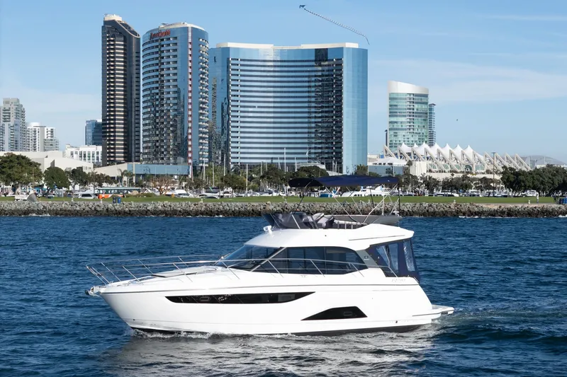 The Image of 2024 Bavaria R40 yacht cruising in urban waterfront with modern skyscrapers in background. - 0