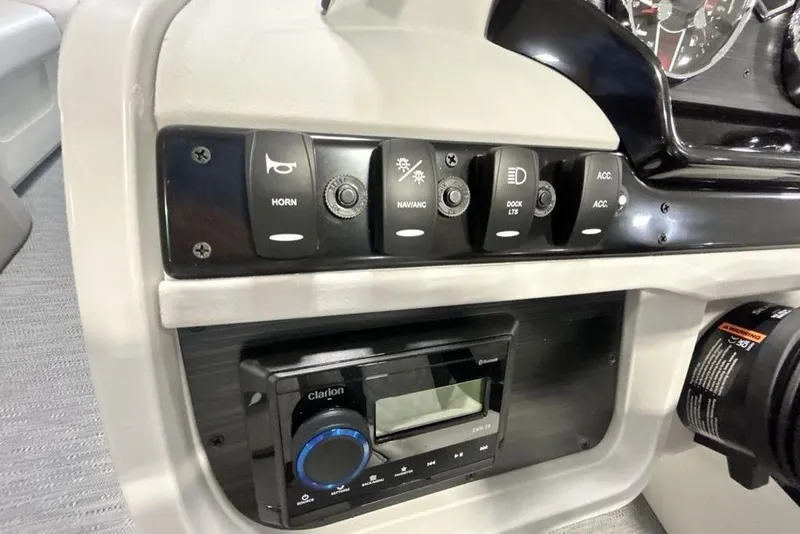 Slide: The Image of Control panel of 2026 Godfrey Sweetwater 2286 SFL boat with switches and stereo system. - 3