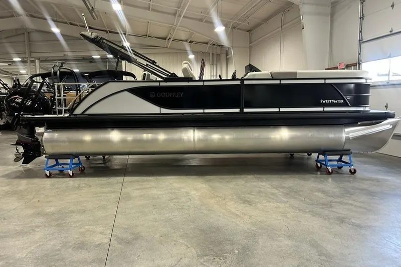 The Image of 2026 Godfrey Sweetwater 2286 SFL pontoon boat in showroom, featuring iMPACT Center Tube Package. - 1