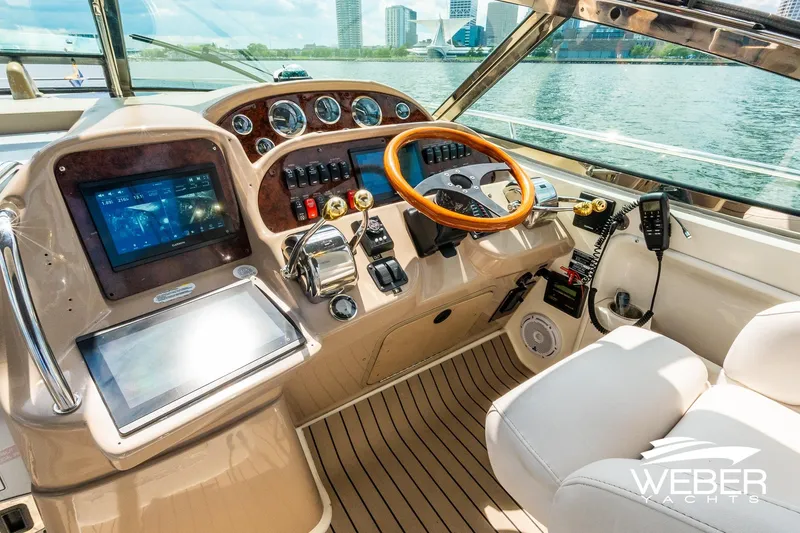 Slide: The Image of Helm of a Sea Ray 360 Sundancer with wood accents and modern instruments. - 8