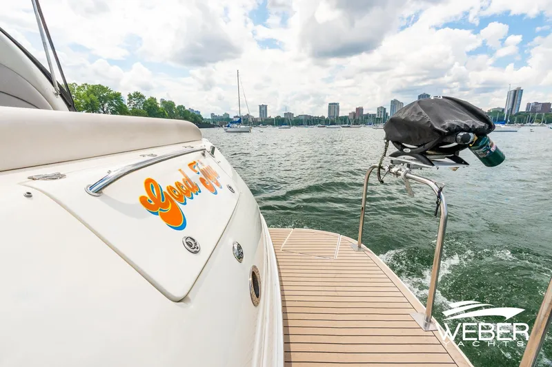 Slide: The Image of The stern of a 2005 Sea Ray 360 Sundancer on a lake with a city skyline. - 4