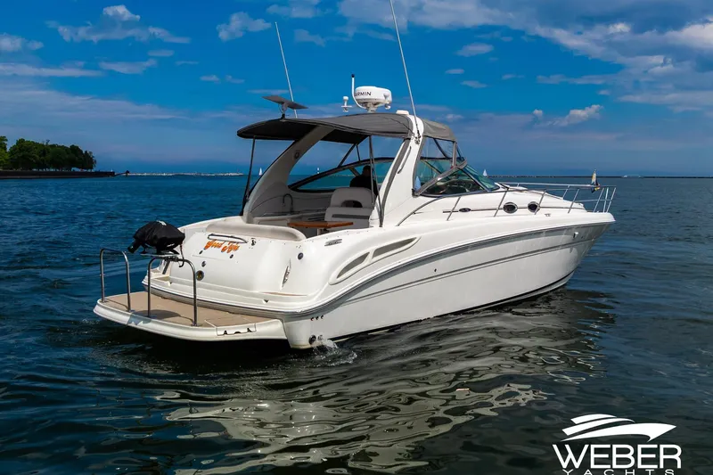 Slide: The Image of A 2005 Sea Ray 360 Sundancer on calm water with a clear sky. - 39