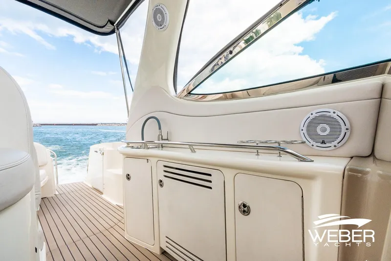 Slide: The Image of The image shows the deck of a 2005 Sea Ray 360 Sundancer with a view of the sea. - 9